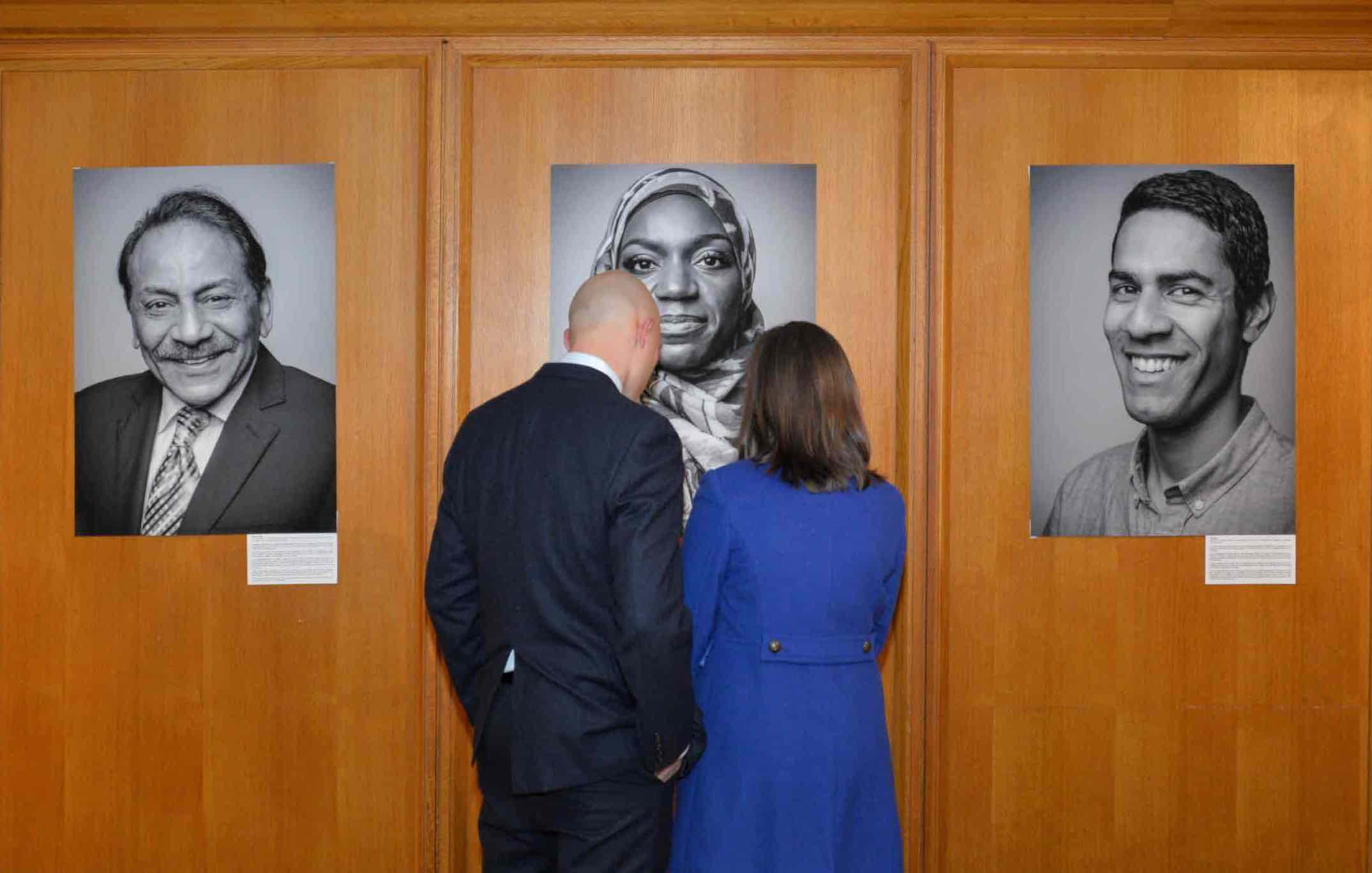 2 people looking at a photo narrative exhibit