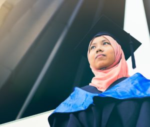 Malaysian student wearing graduation robes and hat
