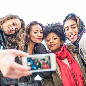 Group of attractive young women of different ethnics taking a selfie