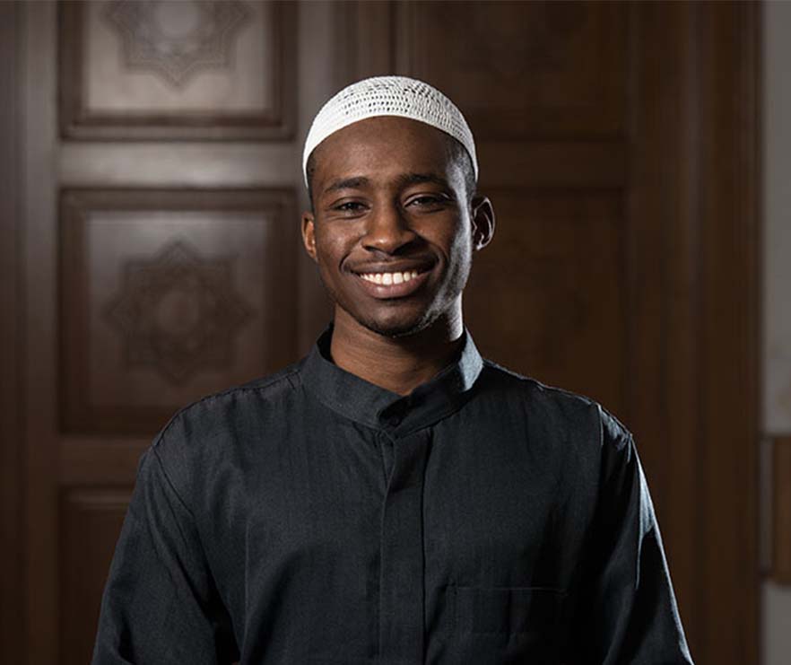 Young African American Muslim Man Wearing a Traditional Cap Dishdasha