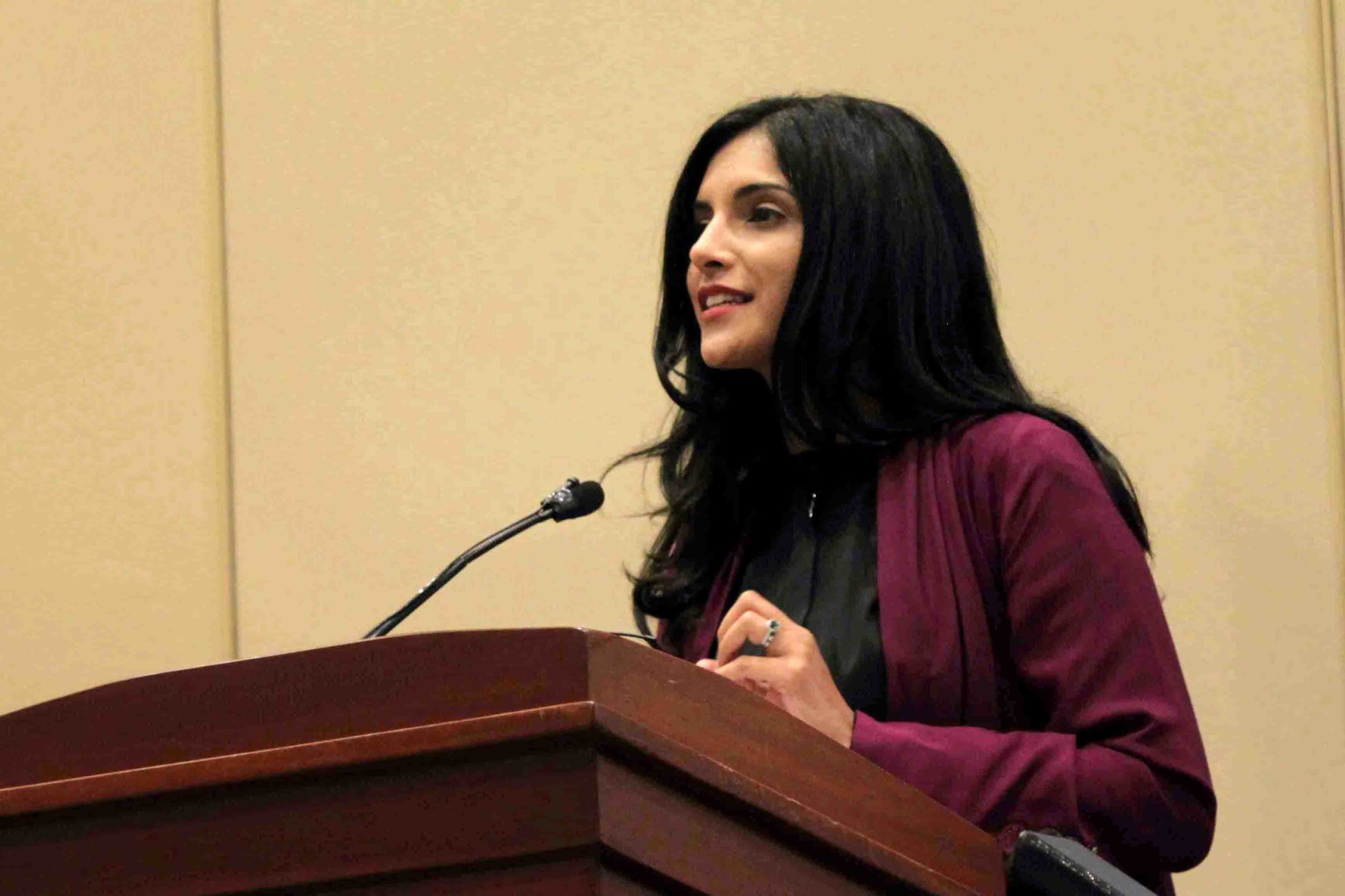 Samar Kaukab at a podium debating engagement vs. boycott at the 2015 ISNA Convention