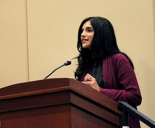 Samar Kaukab speaking at a podium