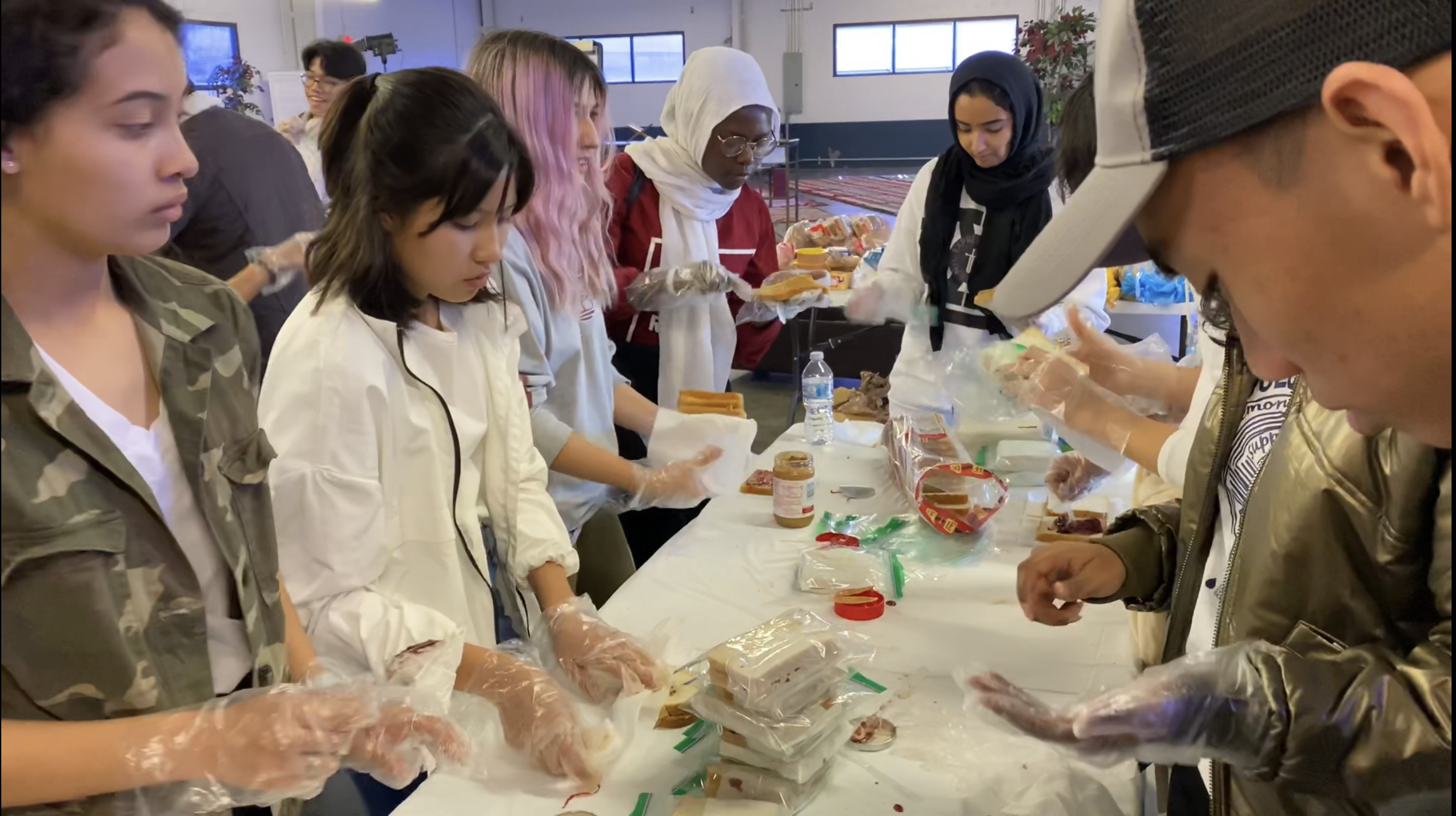 Youth making sandwiches and packing supplies for IslamInSpanish's 'Project Downtown' outreach event providing essentials for the homeless of downtown Houston, TX.